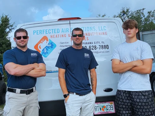 Perfected Air Solutions team - three HVAC technicians standing in front of their service van